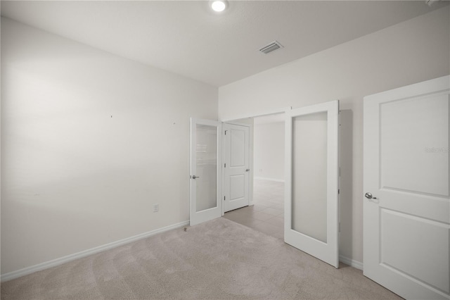 unfurnished bedroom featuring carpet floors, visible vents, and baseboards