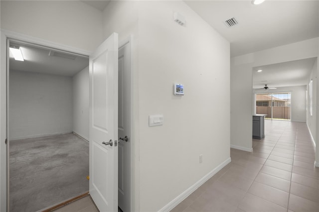 hallway with baseboards, visible vents, recessed lighting, and light tile patterned floors