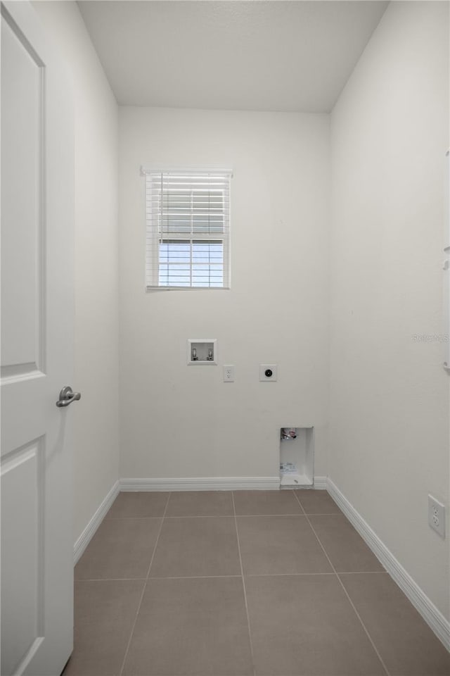 clothes washing area featuring tile patterned floors, electric dryer hookup, baseboards, laundry area, and washer hookup