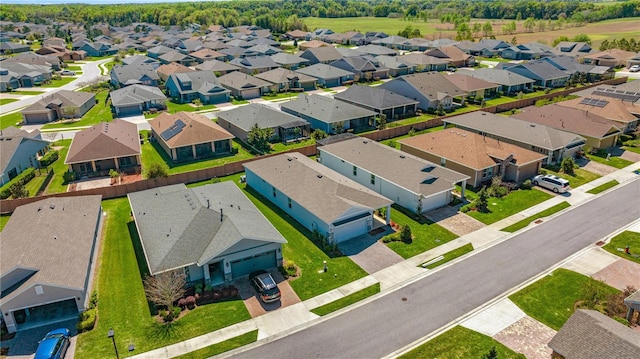 birds eye view of property with a residential view