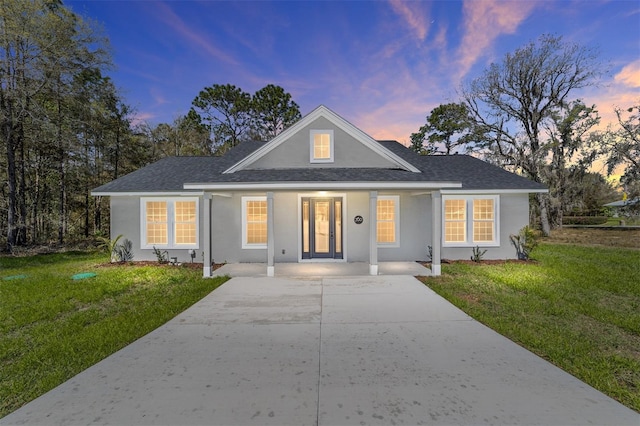 760 NE 152nd Ter, Williston, FL 32696 - bungalow-style home with covered porch, stucco siding, concrete driveway, and a front yard