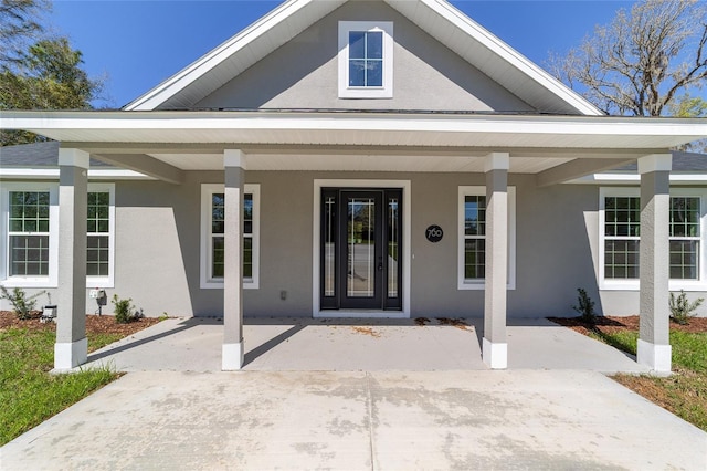 760 NE 152nd Ter, Williston, FL 32696 - property entrance featuring covered porch and stucco siding