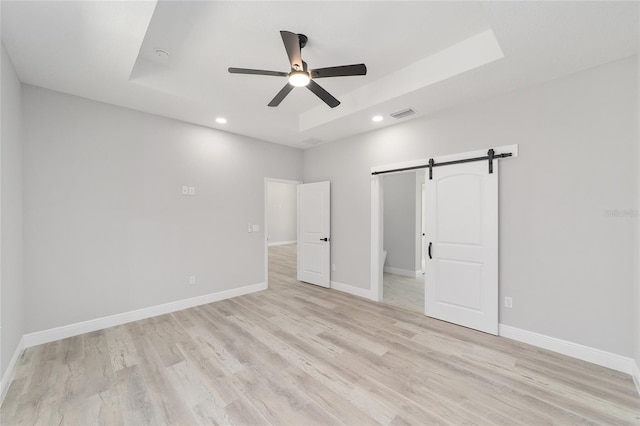 760 NE 152nd Ter, Williston, FL 32696 - unfurnished bedroom with light wood-type flooring, a raised ceiling, and baseboards