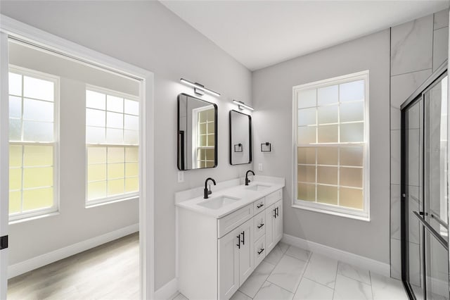 760 NE 152nd Ter, Williston, FL 32696 - full bathroom with double vanity, marble finish floor, baseboards, and a sink