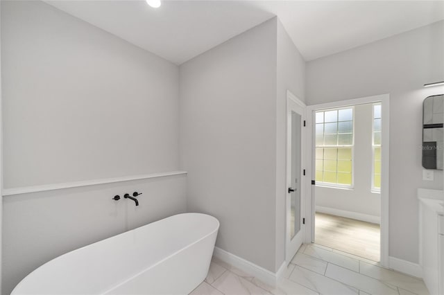 760 NE 152nd Ter, Williston, FL 32696 - bathroom featuring a freestanding tub, baseboards, and marble finish floor