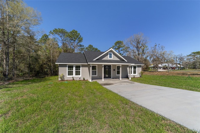 760 NE 152nd Ter, Williston, FL 32696 - view of front of house with a front lawn, driveway, and stucco siding
