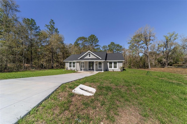 760 NE 152nd Ter, Williston, FL 32696 - view of front of property featuring a front lawn, concrete driveway, and stucco siding