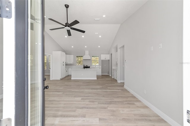 760 NE 152nd Ter, Williston, FL 32696 - unfurnished living room featuring baseboards, high vaulted ceiling, recessed lighting, ceiling fan, and light wood-type flooring
