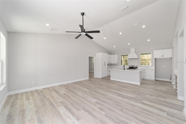 760 NE 152nd Ter, Williston, FL 32696 - unfurnished living room featuring light wood finished floors, baseboards, a ceiling fan, and a sink