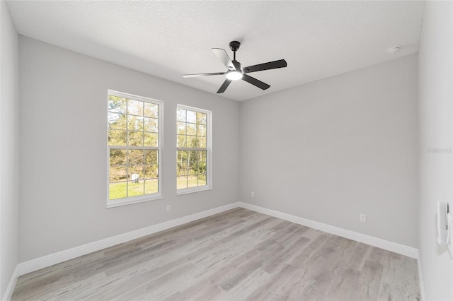 760 NE 152nd Ter, Williston, FL 32696 - unfurnished room with baseboards, light wood-style floors, a ceiling fan, and a textured ceiling