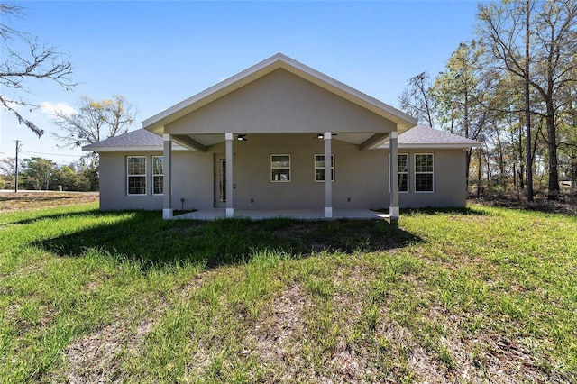 760 NE 152nd Ter, Williston, FL 32696 - back of property featuring stucco siding, a lawn, ceiling fan, and a patio area