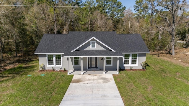 760 NE 152nd Ter, Williston, FL 32696 - view of front of home featuring stucco siding, concrete driveway, a front yard, and roof with shingles