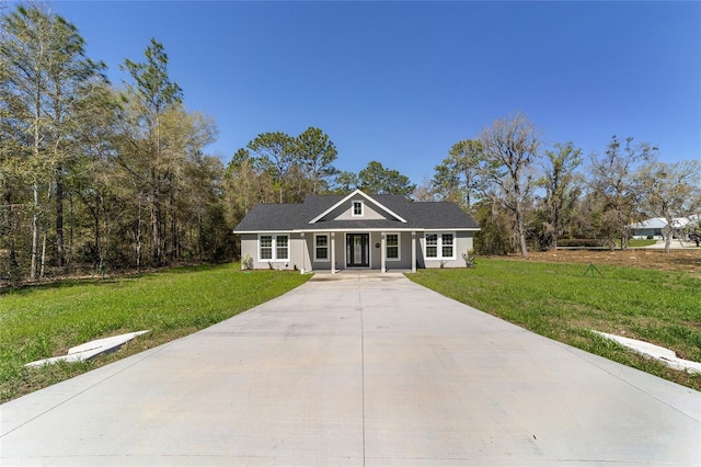 760 NE 152nd Ter, Williston, FL 32696 - view of front facade with a front yard, driveway, and stucco siding