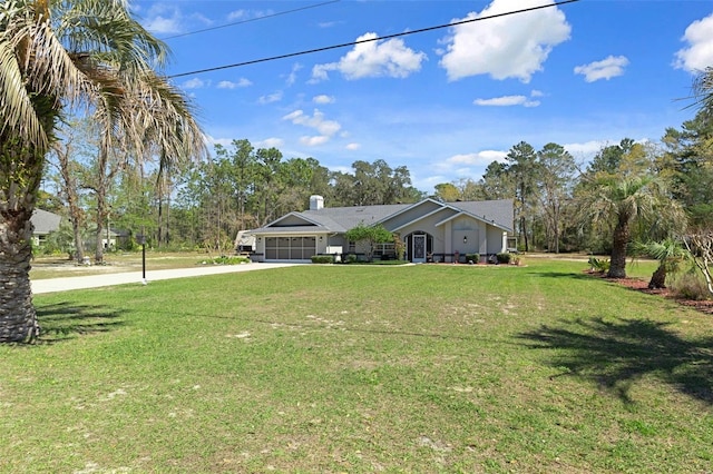 5557 N Sierra Ter, Beverly Hills, FL 34465 - view of front facade with a garage, driveway, and a front lawn