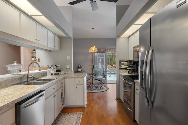5557 N Sierra Ter, Beverly Hills, FL 34465 - kitchen featuring a sink, light countertops, ceiling fan, light wood finished floors, and stainless steel appliances