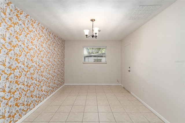 3910 SE 14th Ter, Gainesville, FL 32641 - empty room with wallpapered walls, a chandelier, and light tile patterned floors