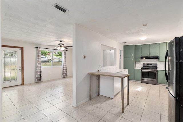 3910 SE 14th Ter, Gainesville, FL 32641 - kitchen featuring green cabinetry, stainless steel gas stove, freestanding refrigerator, light tile patterned flooring, and ceiling fan
