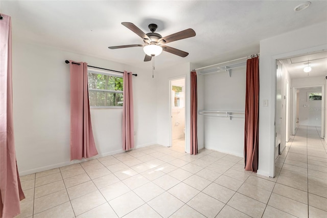 3910 SE 14th Ter, Gainesville, FL 32641 - unfurnished bedroom with attic access, a closet, light tile patterned flooring, and ceiling fan