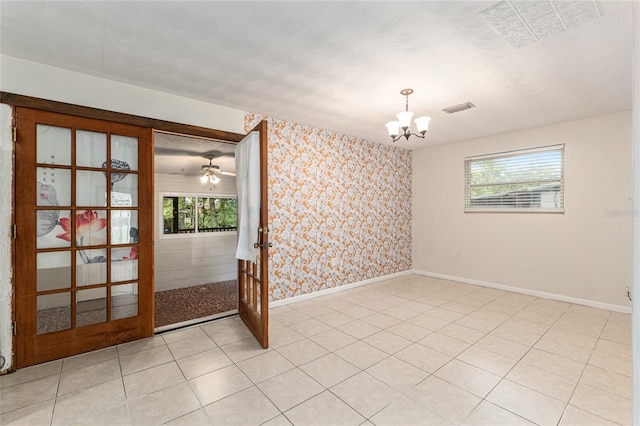 3910 SE 14th Ter, Gainesville, FL 32641 - unfurnished room with wallpapered walls, a chandelier, plenty of natural light, and french doors