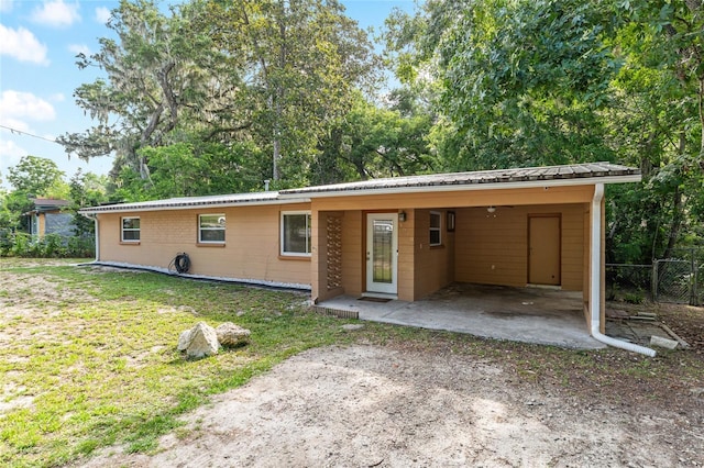 3910 SE 14th Ter, Gainesville, FL 32641 - view of front of property with a metal roof, an attached carport, and dirt driveway