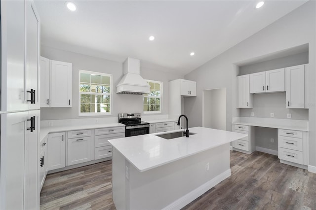 791 NE 150th Ave, Williston, FL 32696 - kitchen with custom range hood, a sink, stainless steel electric stove, wood finished floors, and lofted ceiling