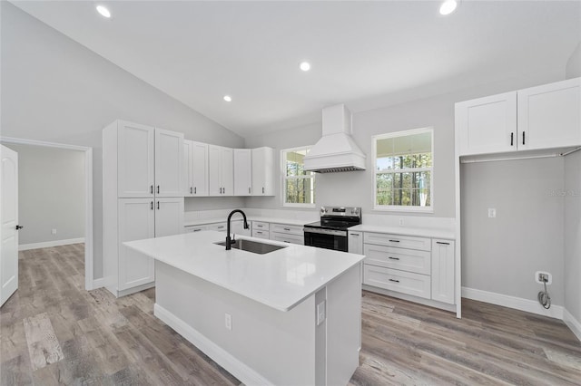 791 NE 150th Ave, Williston, FL 32696 - kitchen featuring white cabinetry, custom exhaust hood, stainless steel range with electric stovetop, and a sink
