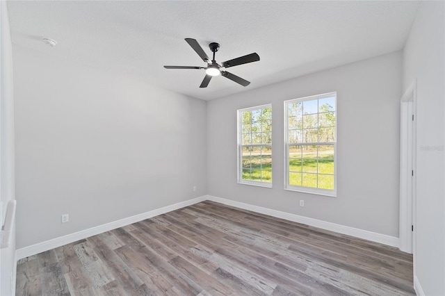 791 NE 150th Ave, Williston, FL 32696 - spare room with baseboards, a textured ceiling, wood finished floors, and a ceiling fan
