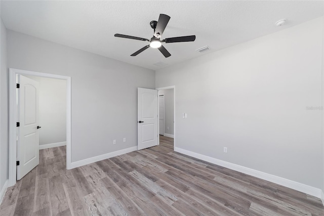 791 NE 150th Ave, Williston, FL 32696 - unfurnished bedroom featuring ceiling fan, wood finished floors, visible vents, and baseboards
