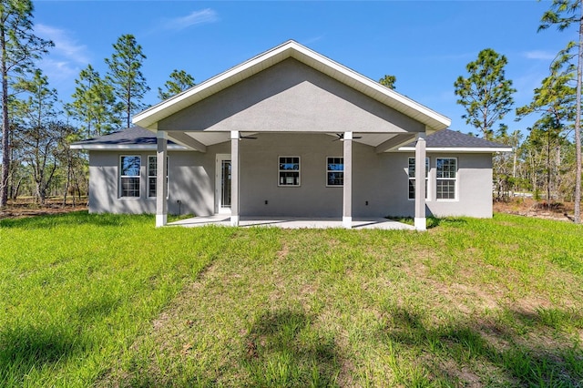 791 NE 150th Ave, Williston, FL 32696 - back of house featuring a yard, stucco siding, a patio, and a ceiling fan