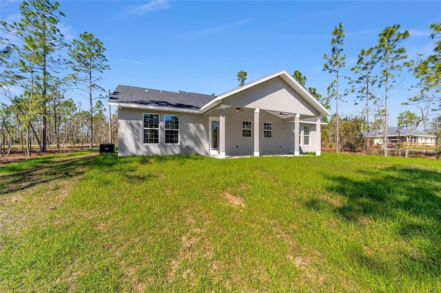 791 NE 150th Ave, Williston, FL 32696 - rear view of property with a yard, a ceiling fan, and stucco siding
