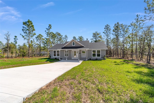 791 NE 150th Ave, Williston, FL 32696 - view of front of house with stucco siding, concrete driveway, and a front lawn