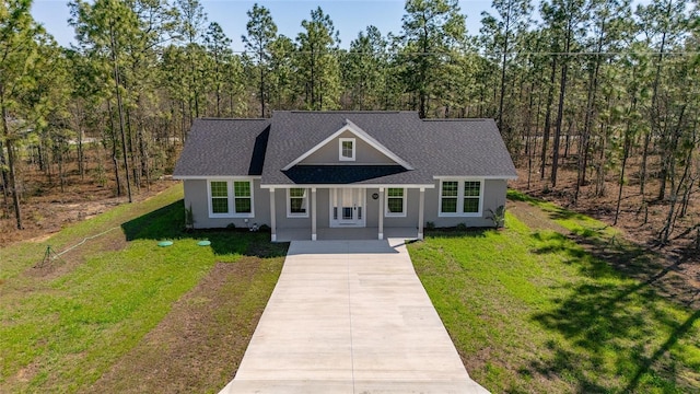 791 NE 150th Ave, Williston, FL 32696 - view of front of house featuring stucco siding, a front lawn, roof with shingles, and driveway