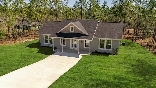 791 NE 150th Ave, Williston, FL 32696 - view of front of property featuring stucco siding, a front yard, driveway, and a shingled roof
