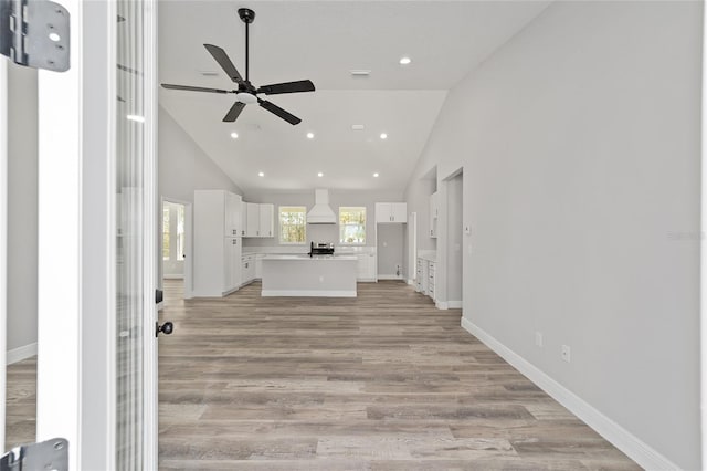 791 NE 150th Ave, Williston, FL 32696 - unfurnished living room featuring high vaulted ceiling, a ceiling fan, light wood-style floors, and baseboards