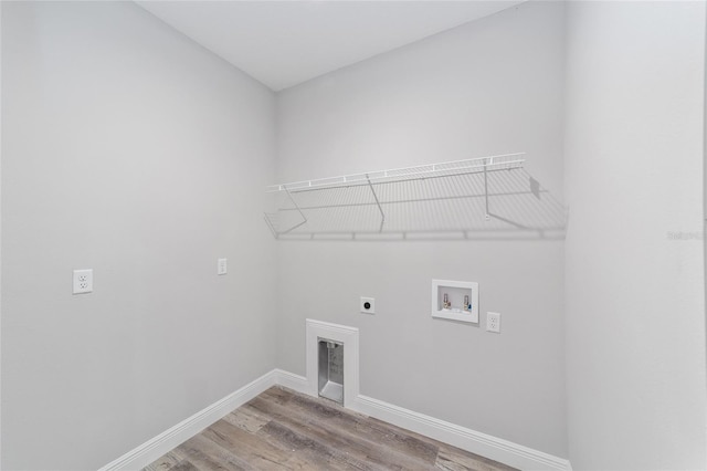791 NE 150th Ave, Williston, FL 32696 - washroom featuring baseboards, laundry area, hookup for a washing machine, wood finished floors, and hookup for an electric dryer