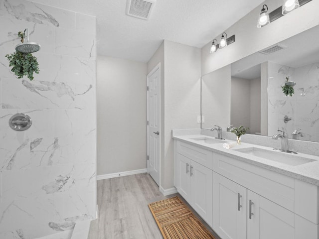 3 Pine Court Ln, Ocala, FL 34472 - bathroom featuring visible vents, a marble finish shower, a sink, and wood finished floors