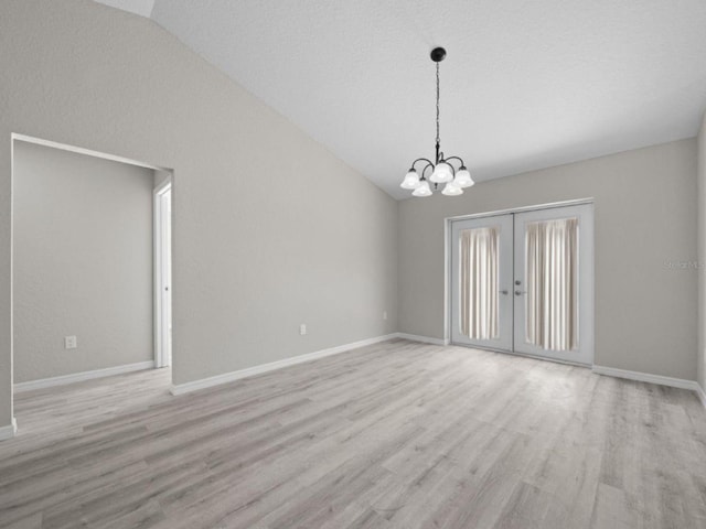 3 Pine Court Ln, Ocala, FL 34472 - spare room featuring baseboards, a notable chandelier, wood finished floors, and lofted ceiling