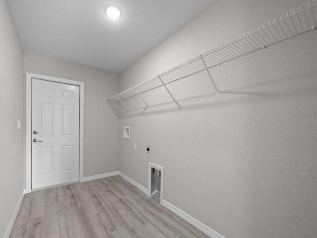 3 Pine Court Ln, Ocala, FL 34472 - clothes washing area featuring laundry area, baseboards, hookup for a washing machine, light wood-type flooring, and hookup for an electric dryer