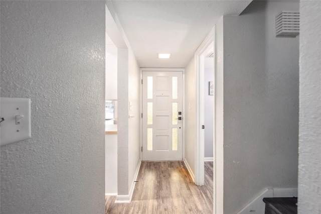 3870 NE 17th Street Cir, Ocala, FL 34470 - corridor with a textured wall, baseboards, and wood finished floors