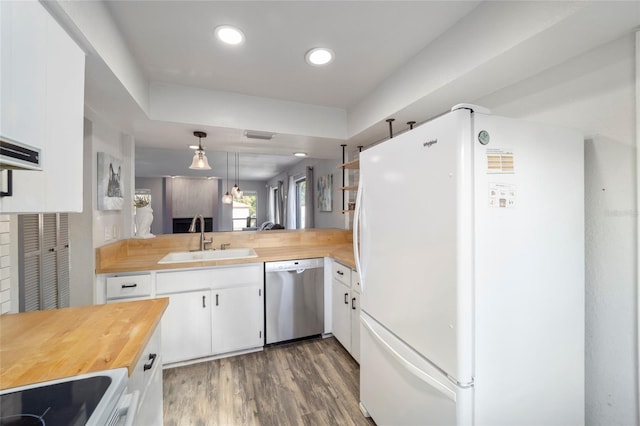 3870 NE 17th Street Cir, Ocala, FL 34470 - kitchen with stove, stainless steel dishwasher, a sink, wood counters, and freestanding refrigerator
