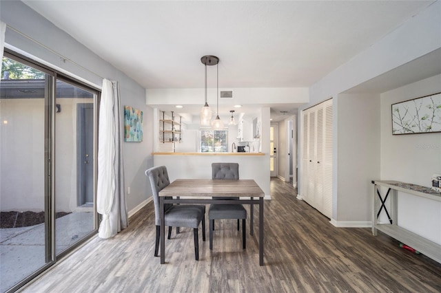 3870 NE 17th Street Cir, Ocala, FL 34470 - dining room featuring visible vents, baseboards, and wood finished floors