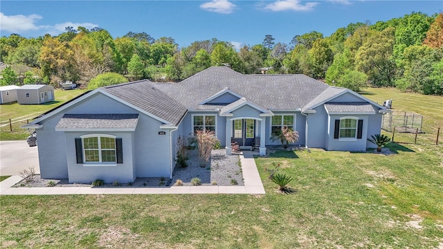 ranch-style house with a front yard, stucco siding, and roof with shingles