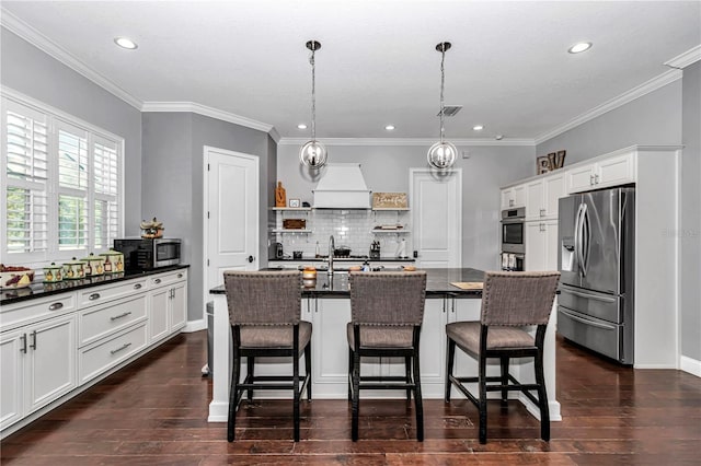 kitchen with open shelves, dark wood-style flooring, dark countertops, appliances with stainless steel finishes, and custom exhaust hood