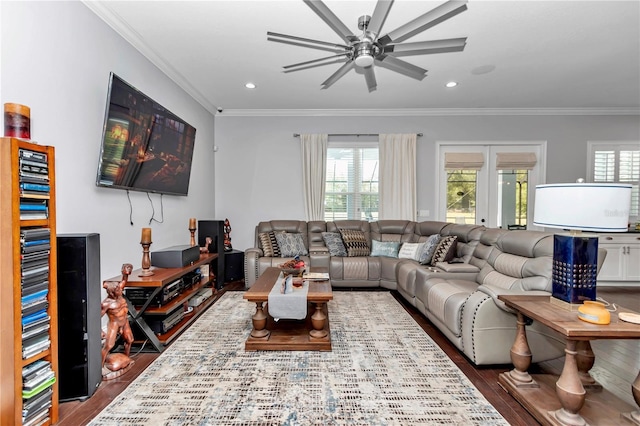 living room with dark wood-style floors, a healthy amount of sunlight, and a ceiling fan