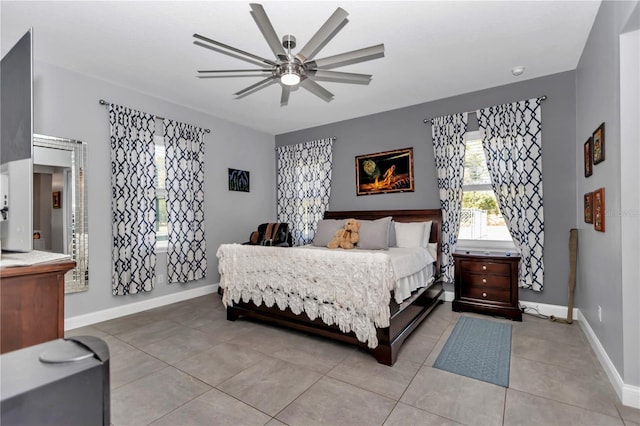 bedroom with baseboards, ceiling fan, and light tile patterned floors