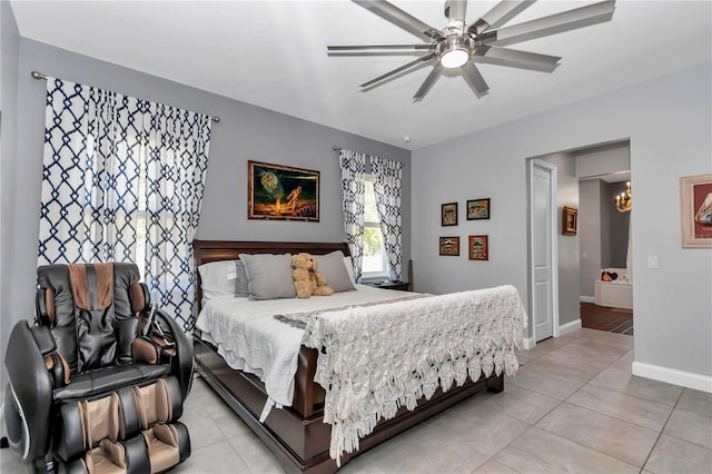 bedroom featuring a ceiling fan, light tile patterned floors, and baseboards
