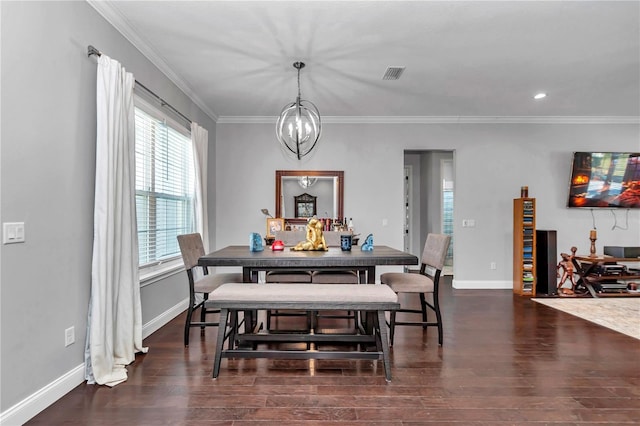 dining room featuring dark wood-style floors, visible vents, ornamental molding, and baseboards