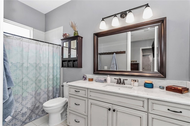 bathroom with tile patterned floors, a shower with shower curtain, toilet, and vanity
