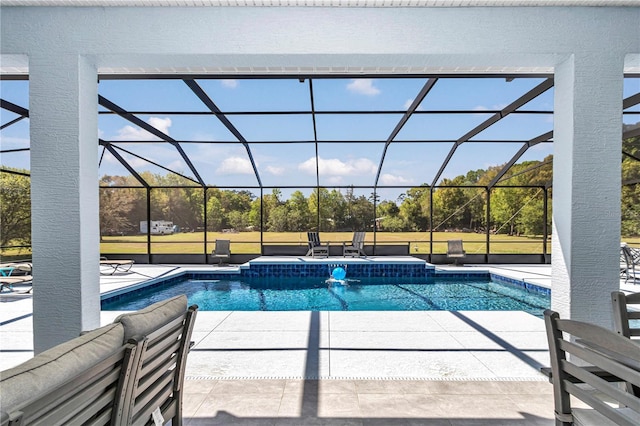 pool featuring glass enclosure and a patio area