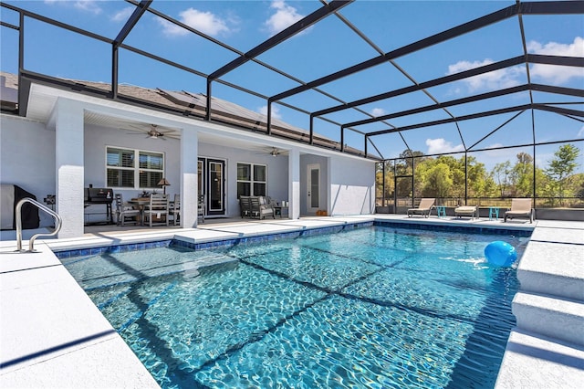 outdoor pool featuring outdoor dining area, glass enclosure, ceiling fan, and a patio area